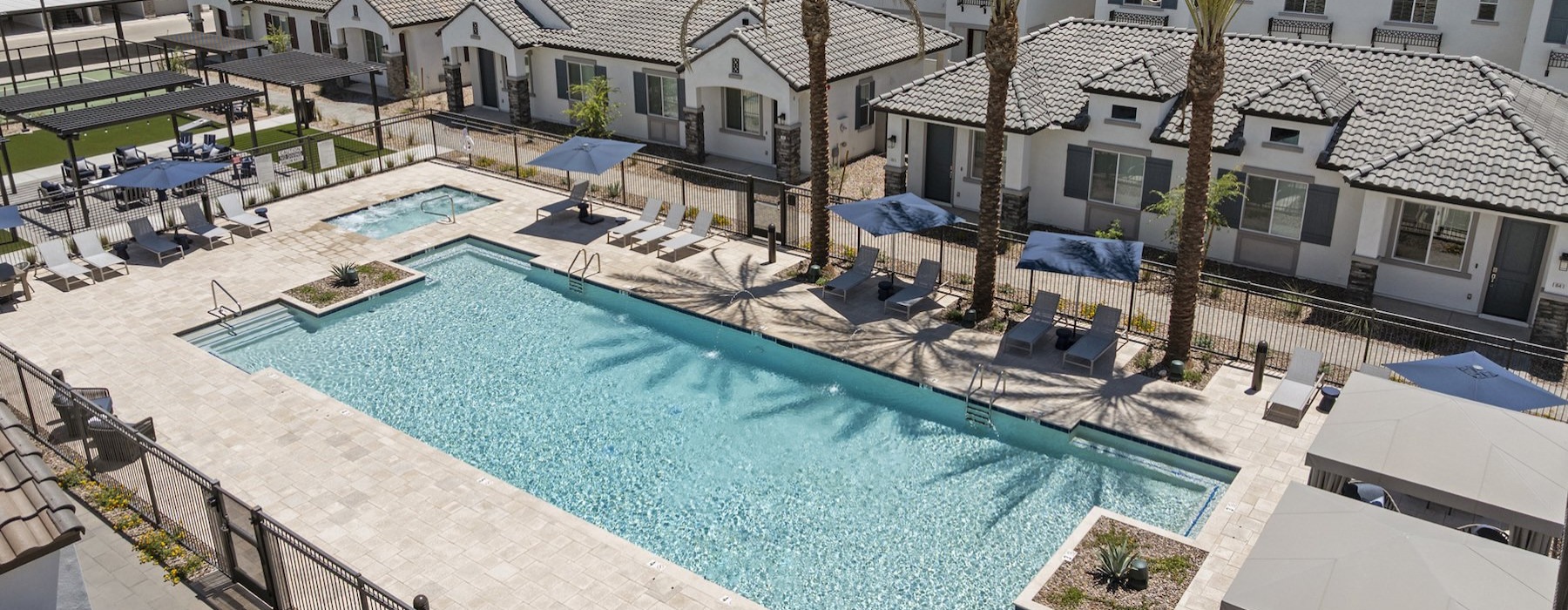 Resort-style swimming pool with lounge seating