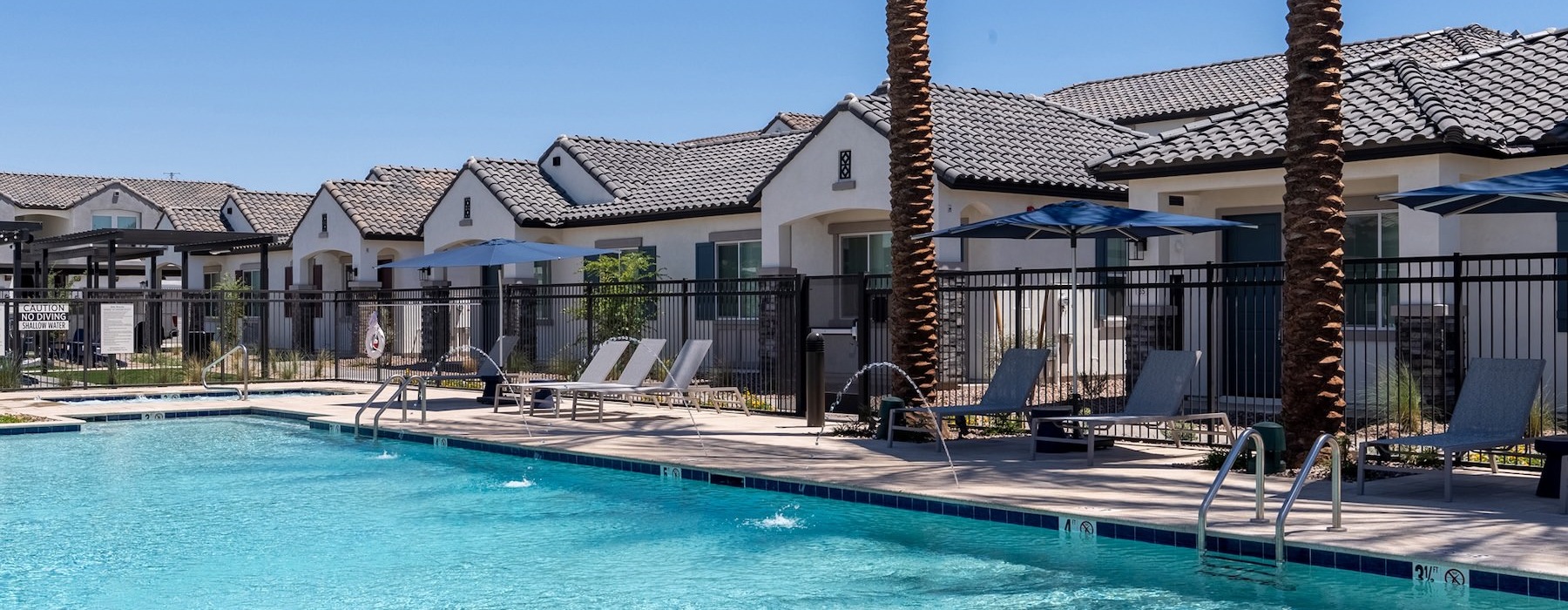 Resort-style swimming pool with lounge seating