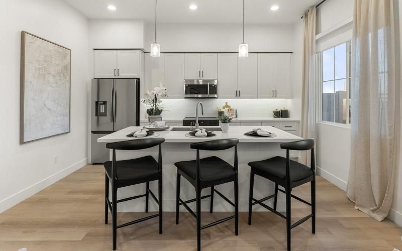 a kitchen with a table and chairs